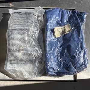 Unopened blue lab apron and lab glasses